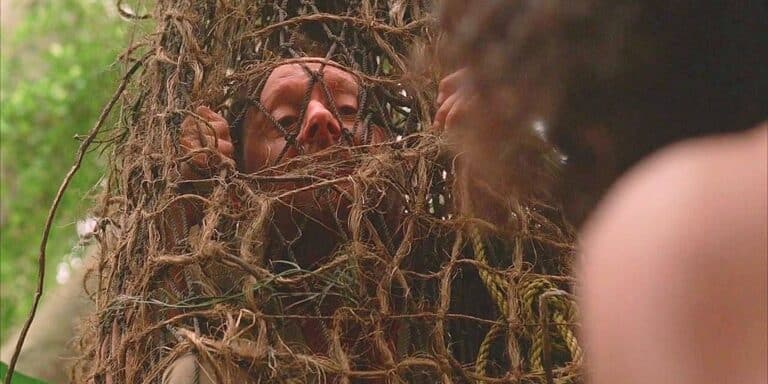 Ben Linus like Henry Gale looking through a net hanging in the jungle on the Lost series