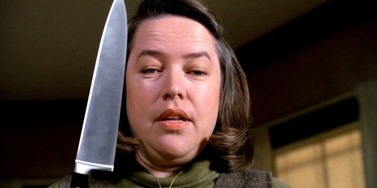 Annie Wilkes threatens Paul Sheldon with a knife in misery.