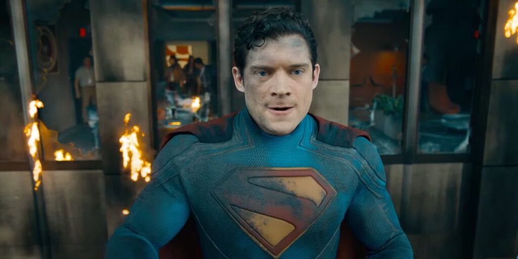 A superman damaged by the battle, played by David Corenswet, in his red and blue costume of the film Superman