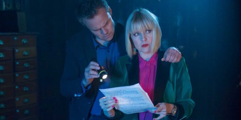 Agatha holding a letter to Agatha Raisin