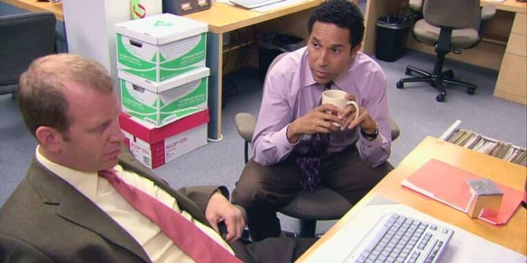 Paul Lieberstein as Toby and Oscar Nuñez as Oscar discussing octagons at the office "Launch party"