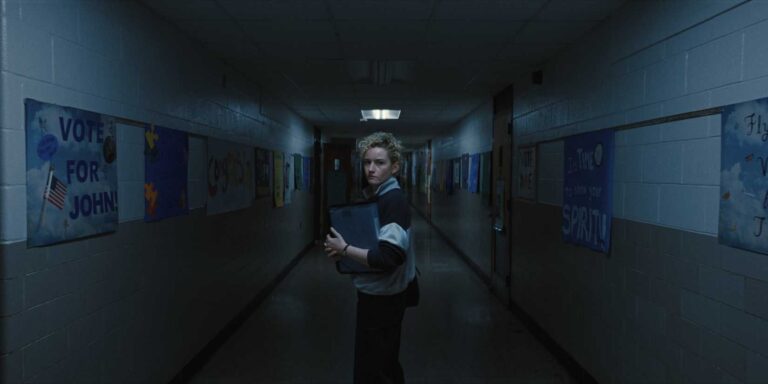 Julia Garner explores a dark school corridor in a dream sequence - Weapons